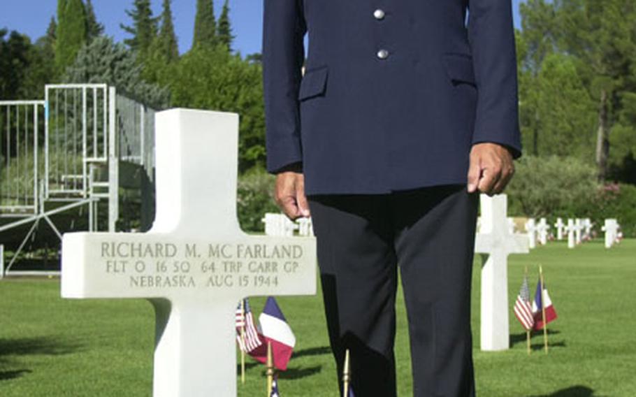 Air Force Master Sgt. David Zibell, a member of the 774th Expeditionary Air Base Group in Istres, France, stands beside his grandfather&#39;s grave at Rhone American Cemetery in Draguignan, France. About 1,500 Americans and French on Saturday evening commemorated the 60th anniversary of the Allied landing in southern France.