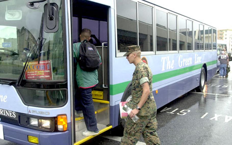 Lance Cpl. Miguel Perez, from 3rd Marines Headquarters Group, boards one of The Green Line’s 46 buses. Perez took the bus from Camp Hansen to Camp Foster for a medical appointment. He said the bus system saves him money as he’s spent $45 for a cab ride from base to base before.