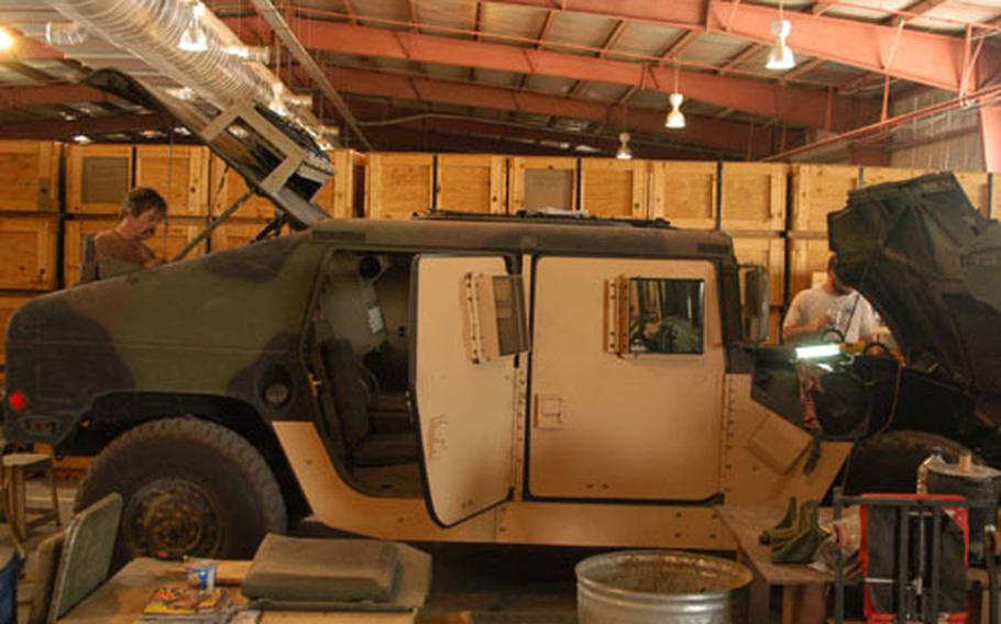 A 2nd Infantry Division Humvee from South Korea has new armored doors and windows and an air conditioner unit installed at Camp Arifjan, Kuwait.