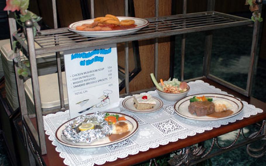 The staff at the Shogun Cafe, Sasebo Naval Base&#39;s galley, displays some of the choices available at each meal. But this is the real thing, not a wax model such as those seen at some Japanese restaurants. The base command is trying get more sailors to utilize the facility.