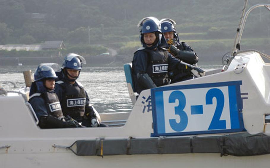 Japanese riot police were present in small boats just in case things got out of hand as about 150 Japanese protesters rode in about 20 fishing boats and shouted in megaphones to express their disapproval of the USS John C. Stennis&#39; port call at Sasebo Naval Base on Saturday. The protest was loud, but peaceful.
