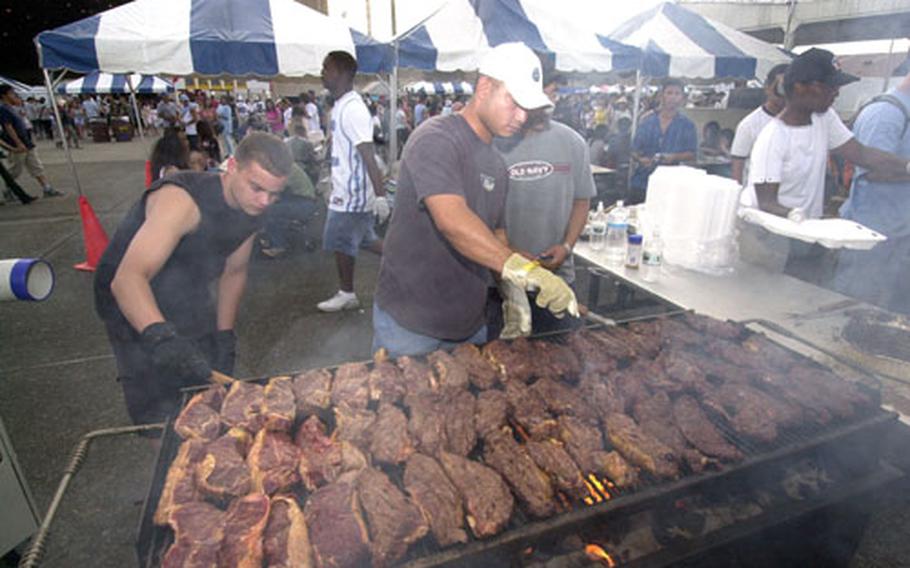 Staff Sgt. Michael Cooper and Staff Sgt. Fernando Mendiola of the 374th Logistics Readiness Squadron cook up some steaks for hungry visitors at the Friendship Day Festival on Yokota Air Base. They estimated that they would grill over 2000 steaks for the two day event.