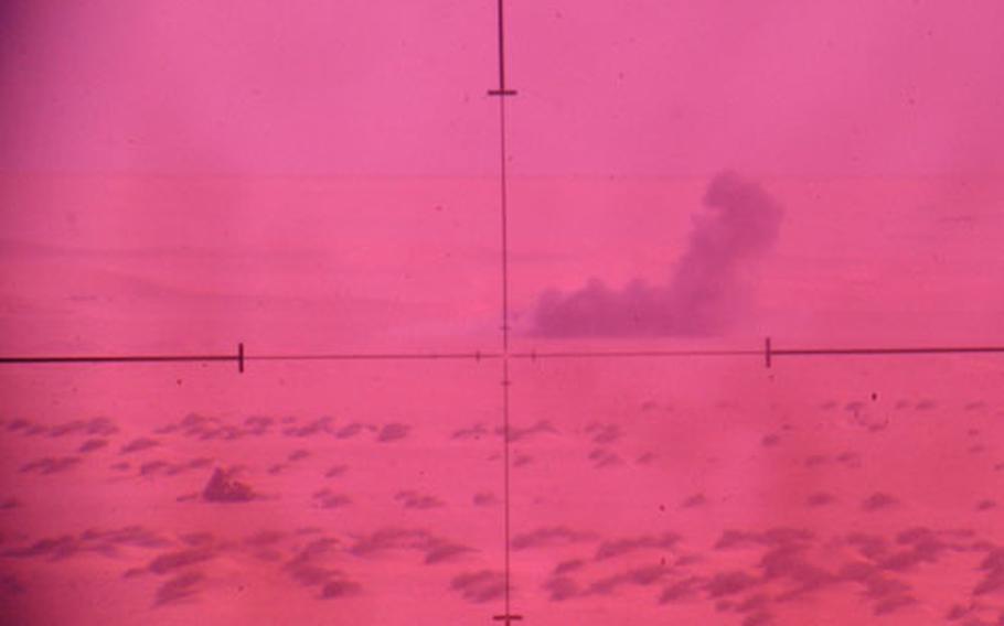 The view through a laser-designator: A derelict truck disappears in smoke after being hit by a Copperhead round at Udairi Range, Kuwait.