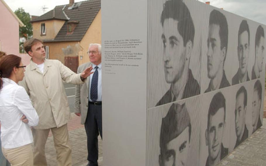 German architect Peter Karle (second from left) shows Rüsselsheim residents Dagmar Eichorn, left, and Martin Schlappner a monument honoring seven U.S. airmen killed by a mob in Rüsselsheim, Germany, 50 years ago this week during World War II.