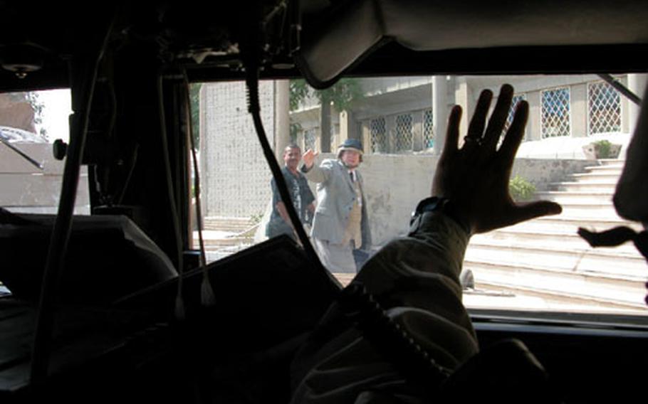 Jeffry Brinkley, the U.S. Embassy’s health attaché, waves goodbye to convoy escort leader 1st Lt. Waylon Gross before entering the Iraqi Ministry of Health in Baghdad.