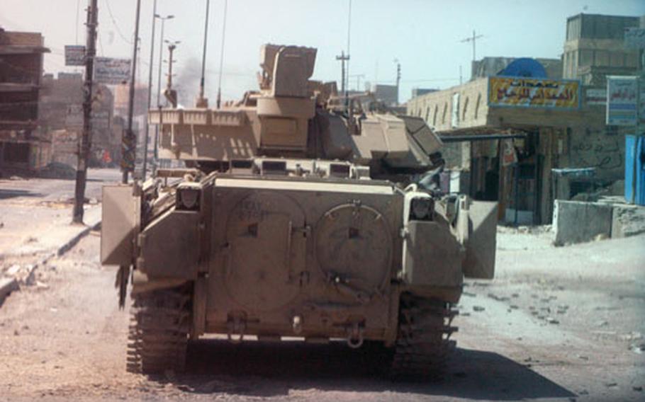 A Bradley armored fighting vehicle with Company C, 2nd Battalion, 7th Cavalry Regiment, sits on a Najaf street Thursday morning.