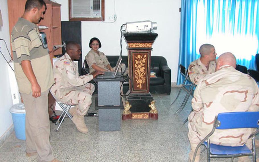 Capt. Reggie Kornegay, seated at computer, is the leader of the 1st Battalion, 9th Cavalry Regiment’s new Iraqi Police Leaders Operational Assistance and Development Course.