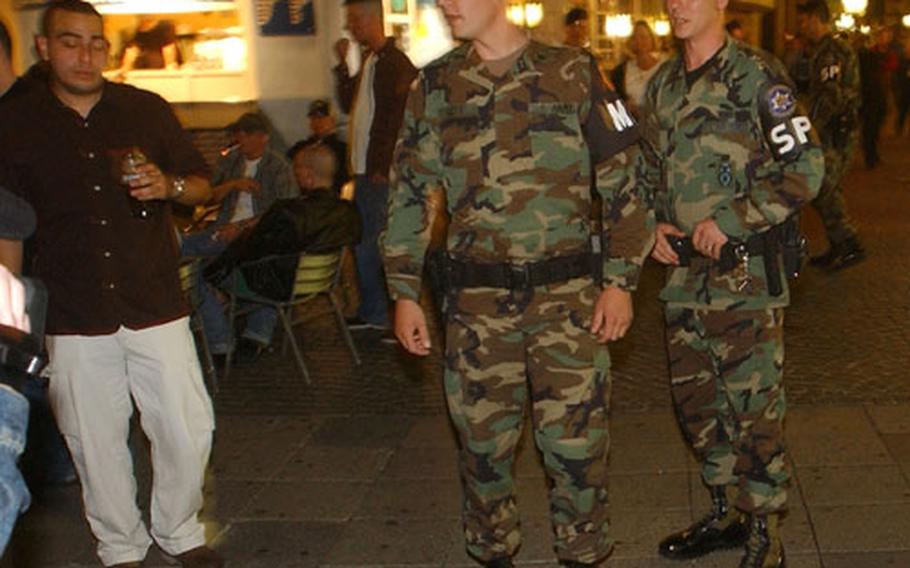 From right, Air Force Staff Sgt. Christopher Casey and Army Staff Sgt. Jessie Goff, respond to call of a disturbance while on patrol of a bar district with German Polizei officers in Kaiserslautern, Germany, on Friday night. The patrolmen are part of the 569th U.S. Forces Police Squadron in Vogelweh, Germany.