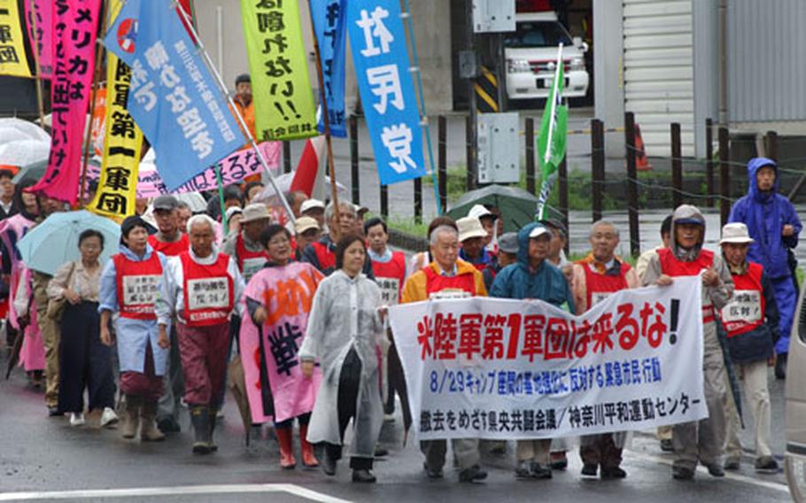 Japanese protestors, demonstrating in opposition to unconfirmed reports of Army troop movement plans, march together from Sobudaimai Train Station to Camp Zama&#39;s Main Gate Sunday.