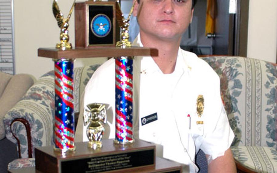 Officer Thomas Epperson, drillmaster of Sasebo Naval Base&#39;s Command U.S. Naval Forces Japan Regional Fire Department, won the U.S. Navy&#39;s Civilian Firefighter of the Year award in July. On Aug. 18, while in New Orleans to receive the Navy award, the surprised Epperson as also named the Department of Defense Civilian Firefighter of the Year from among the estimated 13,000 employed by DOD. Epperson is shown at the Sasebo office with his trophy.
