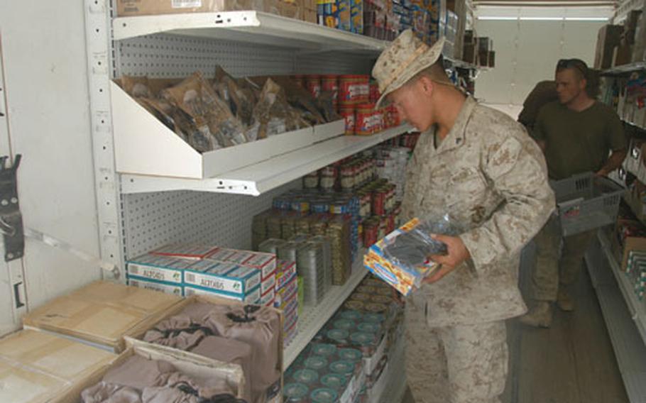 Cpl. Gee Vue of Marine Service Support Group 11 shops at the Camp Duke, Iraq, post exchange on Wednesday. Vue and a few other Marines and soldiers helping to open the exchange were able to shop before Friday&#39;s planned opening.