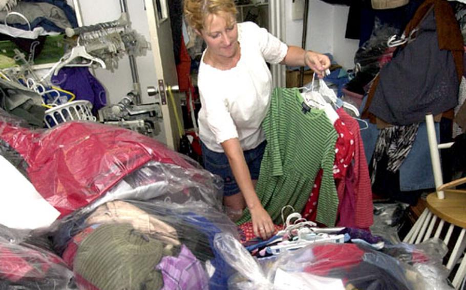 Esther Seep sorts through a pile of donated clothes at the Second Hand Rose shop on Yokosuka Naval Base.