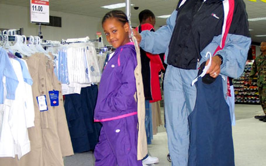 Kimberly Robinson shops for new school clothes for her daughter, Kaylah, 6, at the Bamberg Post Exchange in Germany. Bamberg schools have adopted a school dress code for students.
