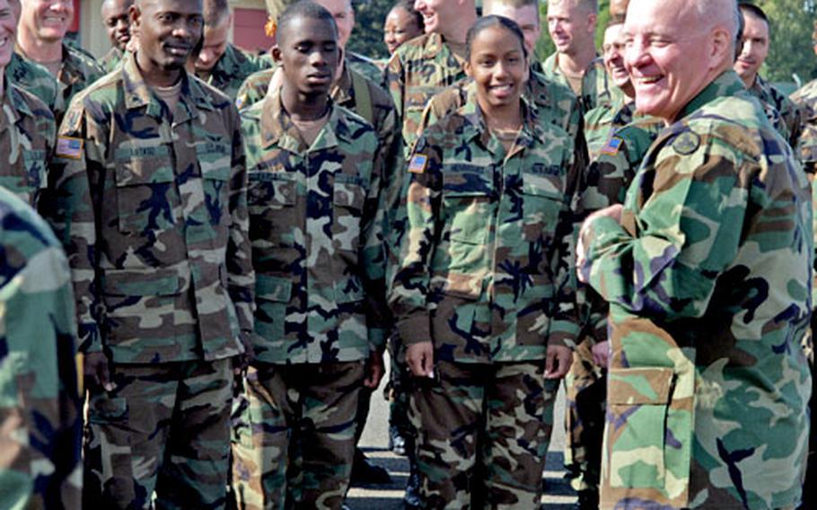 Army Brig. Gen. Vincent E. Boles, right, talks with his soldiers during change-of-command rehearsals Wedesday at Wiesbaden Army Airfield, Germany. On Thursday, Boles turned over command of the 3rd Corps Support Command to Brig. Gen. Rebecca Halstead.