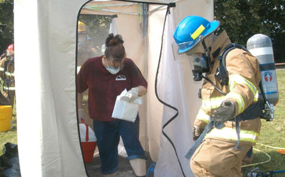 A mock biological contamination casualty exits a decontamination shower during an emergency response exercise held in July at Camp George in Taegu, South Korea.