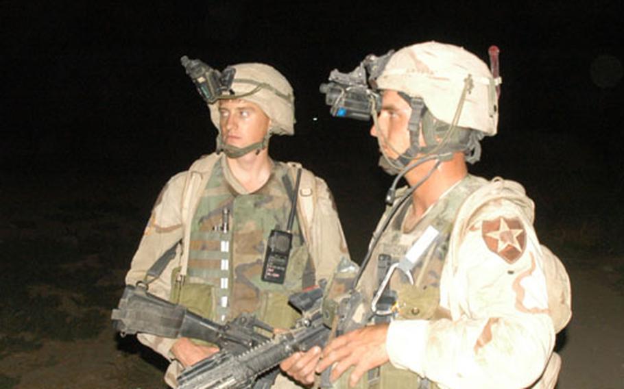 From left: Sgt. George Womack, 27, of Mount Vernon, Wis., (unit information withheld at the request of Strike Force) and Mitch Dodson, 25, of the 2nd Infantry Division&#39;s Company C, 1st Battalion, 9th Infantry Regiment, and of Elsmore, Kan., patrol in the dark in the Manchus&#39; new area of operations in Iraq.