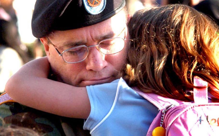 Sgt. 1st Class Hinton Allred gives his daughter, Savannah, 7, a big hug before she marches off to class on the first day of school at Mannheim Elementary. Savannah is in a multi-age first- and second-grade class.