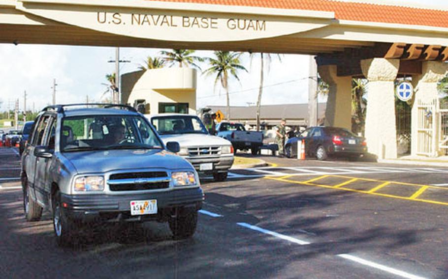 Motor vehicles pass through Naval Base Guam’s new front gate for the first time in several weeks after a ribbon-cutting ceremony Tuesday.