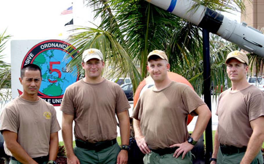 Four members of EODMU5 stand at the entrance to the unit&#39;s compound in Guam following their return from Iraq. They are, left to right, Seaman James "Kimo" Makaneole, Petty Officer 1st Class Tyler Borgwardt, Lt. Will Ranney and Petty Officer First Class Jeffrey Gates.