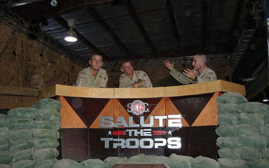From left, Pvt. Camron Craw, Spc. Michael Curtis and Spc. Lucas Monahan, act out their own version of ESPN&#39;s SportsCenter as they were working to build the set last Thursday. Dozens of soldiers took part in creation of the studio and ESPN offices for SportsCenter&#39;s live broadcasts next week. Craw, from Minersville, Utah, is assigned to the 32nd Transportation Company; Curtis, from Miami, is assigned to the 50th Area Support Group, and Monahan, from Andalusia, Ala., is assigned to the 175th Maintenance Co.