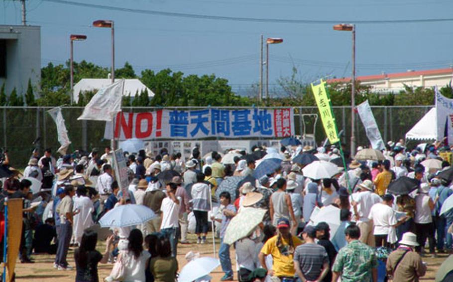 Dozens of banners like this one, stating, "No to the Futenma Air Station," were on display on the athletic field at Okinawa International Univerity during a protest Sunday. The event was sponsored by the city of Ginowan, whose mayor has called for early closure of the air base following a crash of a Marine helicopter at the university Aug. 13. City officials said some 30,000 people attended the rally.