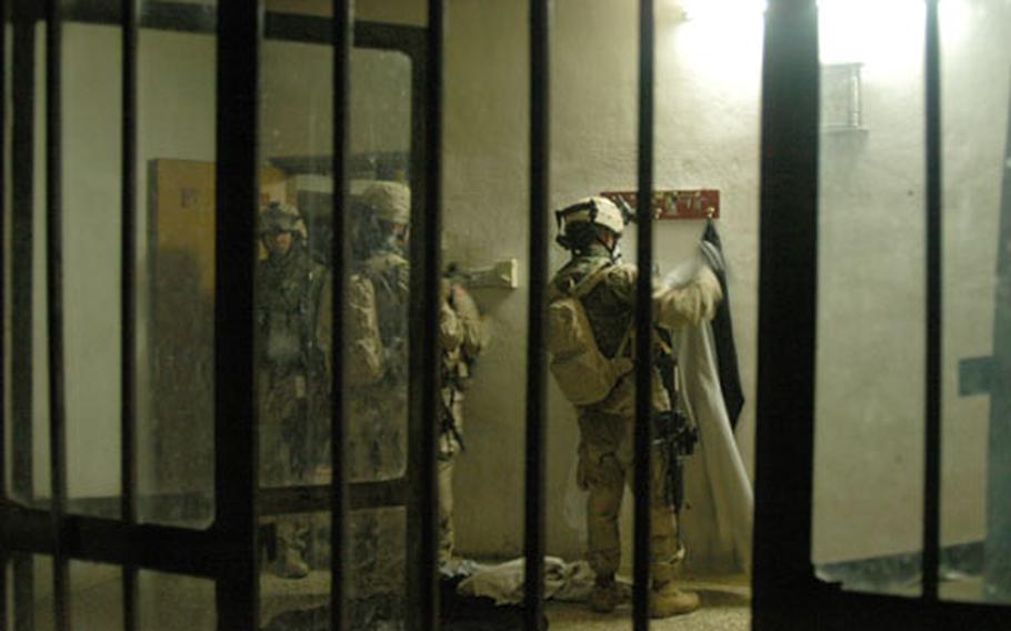Soldiers from Company C, 1st Battalion, 506th Infantry Regiment search a house in Abu Fleis, Iraq, on Saturday.