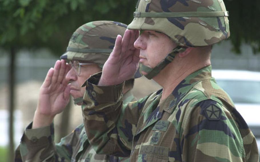 Lt. Gen. Ricardo Sanchez, left, and Command Sgt. Maj. Michael D. Bush salute during a V Corps ceremony welcoming Bush as the new top enlisted soldier of the corps Monday.