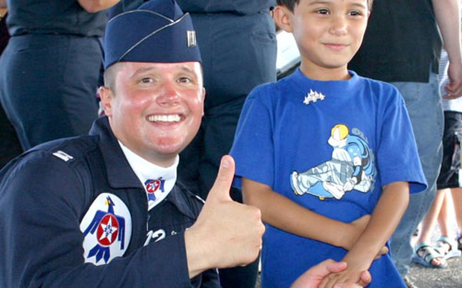 Capt. Steven Rolenc, Thunderbirds public affairs officer, poses with 6-year-old Mark Dell’Isola following the Thunderbirds’ practice show at Andersen Air Force Base, Guam, on Saturday.