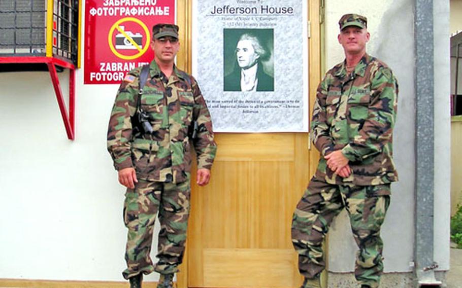 Staff Sgt. Douglas Mitchell, left, and Staff Sgt. Michael Spurgin stand outside the house they and other members of the Indiana National Guard live in in Vlasenica, Bosnia-Herzegovina.