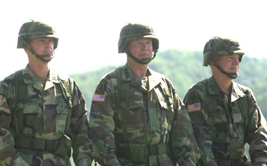 From left, Maj. Gen. George A. Higgins, Lt. Gen. Charles C. Campbell and Maj. Gen. John R. Wood inspect the assembled 2nd Infantry Division troops Tuesday at Camp Casey.
