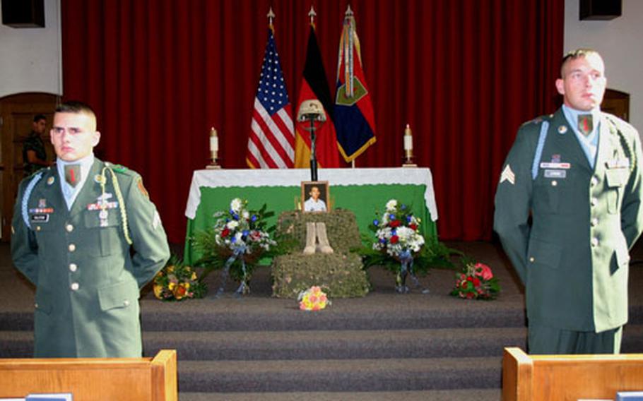 Members of an honor guard flank a memorial display for Spc. Edgar Daclan Jr. at a service in the chapel on Ledward Barracks on Wednesday.