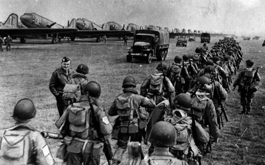 Lines of Allied troops make their way to the loading area of an airfield in England for Operation Market Garden in 1944. It was a major defeat for the Allies, who were still celebrating the successful landings and breakout at Normandy, France.