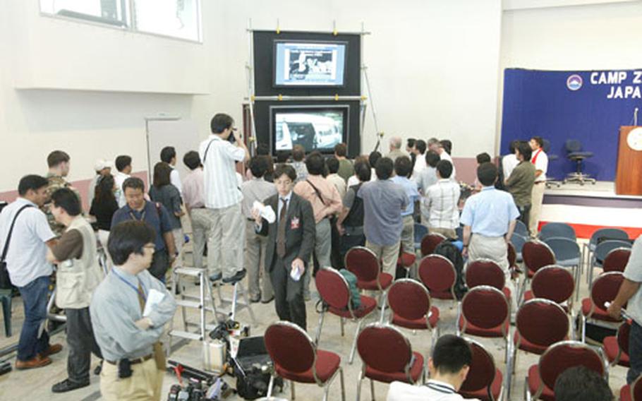 International media members at the Joint Information Bureau set up last Saturday in Camp Zama&#39;s Community Cultural Center observe the video upload on the United States Army Japan Web site.