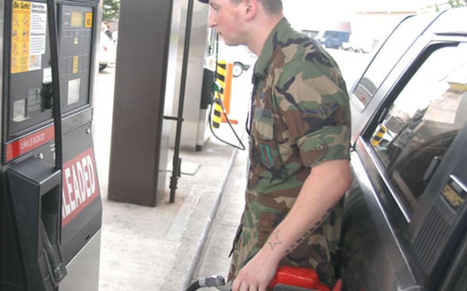 Airman Jeff Catan fills up his vehicle with gas Friday at the AAFES service station on Misawa Air Base, Japan. AAFES announced Friday that starting Oct. 1, fuel prices will change monthly based on a 4-week stateside average.