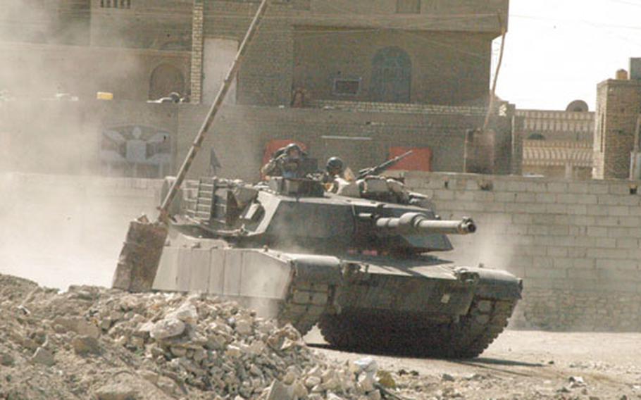 An M1A1 Abrams tank rolls through the streets of Ramadi, Iraq, during fighting with insurgents on Thursday.