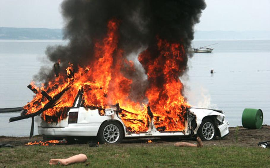 A parked car burns at a beach Friday as part of a weapons of mass destruction exercise at Misawa Air Base, Japan. The exercise tested the 35th Fighter Wing&#39;s ability to respond to WMD incidents as part of the Air Force Weapons of Mass Destruction Installation Training and Exercise Program.