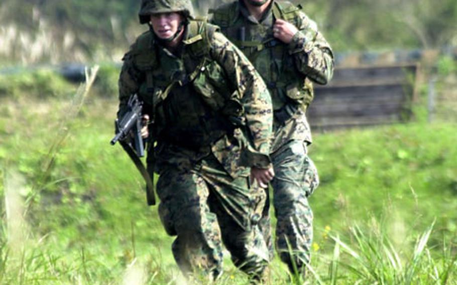 Lance Cpl. Austin Bott, left, advances as Cpl. Jedediah Rice watches Friday during exercise Cloud Warrior 2004 at Camp Fuji.