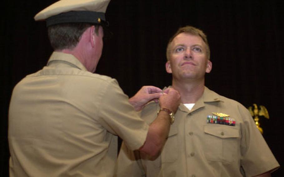 David Furford is pinned during a ceremony Wednesday at Naval Station Rota, Spain. The ceremony for 13 sailors tapped for the chief petty officer rank had been postponed as the result of "inappropriate actions" at an initiation function on base Sept. 9.