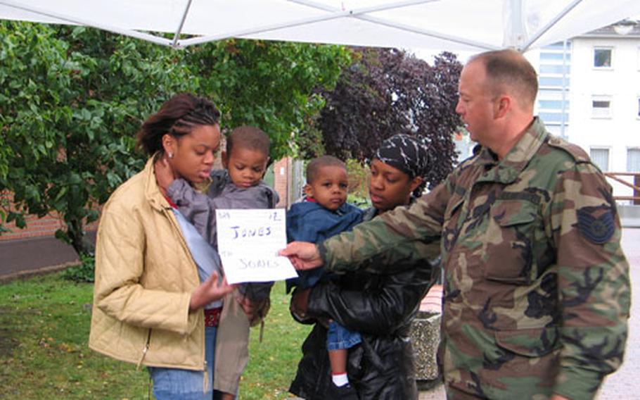Air Force Tech Sgt. Eric Schwab assists Bamberg family members, left to right, Tamara, J&#39;Don, Jamicka and Jamal Jones, of the 1st Battalion, 6th Field Artillery, in making holiday greetings to Savanna, Ill., and Rochester, N.Y. The Hometown News crew, based in Texas, recorded about 110 greetings at Bamberg&#39;s Warner Barracks last week. The Hometown News crews annually record greetings throughout Europe and Asia to bring holiday cheer from military families to the United States. Greetings are expected to air after Dec. 10.