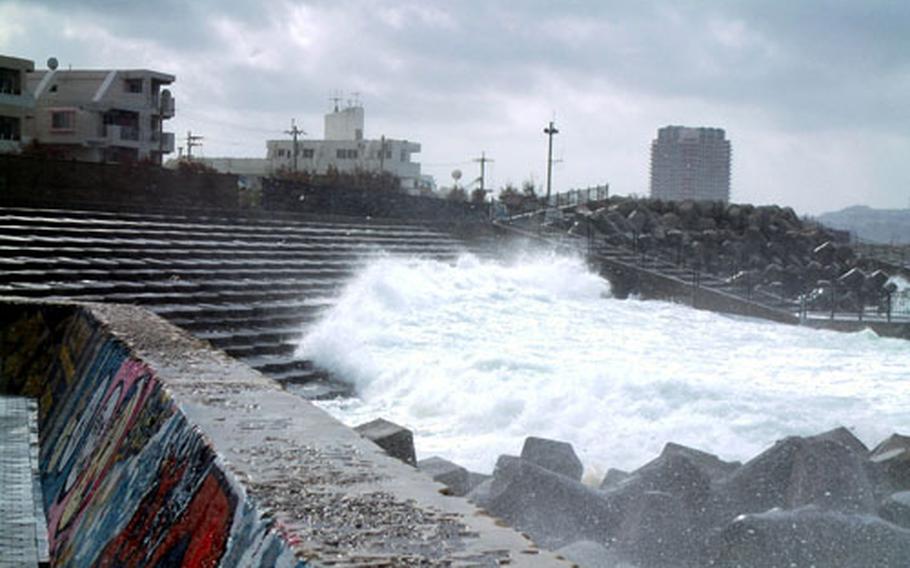 Seas stirred up by Typhoon Meari rush up the steps of the Sunabe Seawall on Okinawa Tuesday morning.