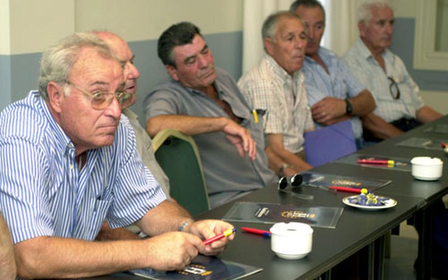 Retired U.S. Navy ship workers who were exposed to asbestos during the 1950s, &#39;60s and &#39;70s listen to attorney Mitchell Cohen at Hotel Playa de la Luz in Rota, Spain, on Tuesday.
