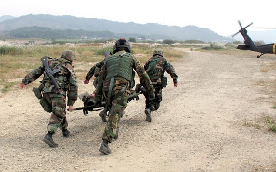 During a battlefield medical evacuation exercise in South Korea on Thursday, soldiers rush a battle casualty to a waiting dustoff helicopter that will fly him to a mock field hospital. The helicopter, Dustoff 3-6, is from the 377th Medical Company (Air Ambulance) out of Camp Humphreys in Pyongtaek, South Korea.