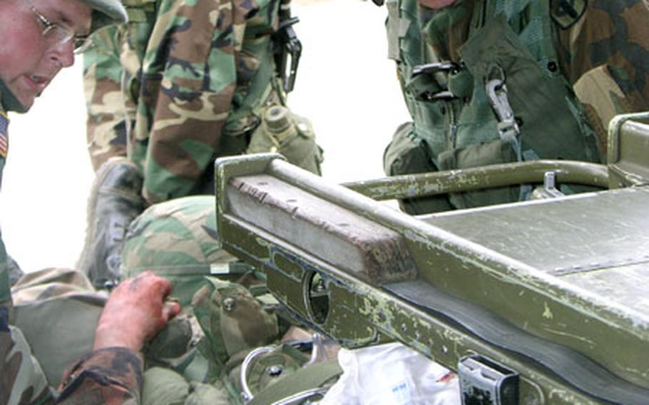 Soldiers load a mock battle casualty onto an Army medical evacuation helicopter. Participants in Thursday’s exercise said the training demonstrated that what awaits medevac crews on the other end of a launch isn’t always predictable.