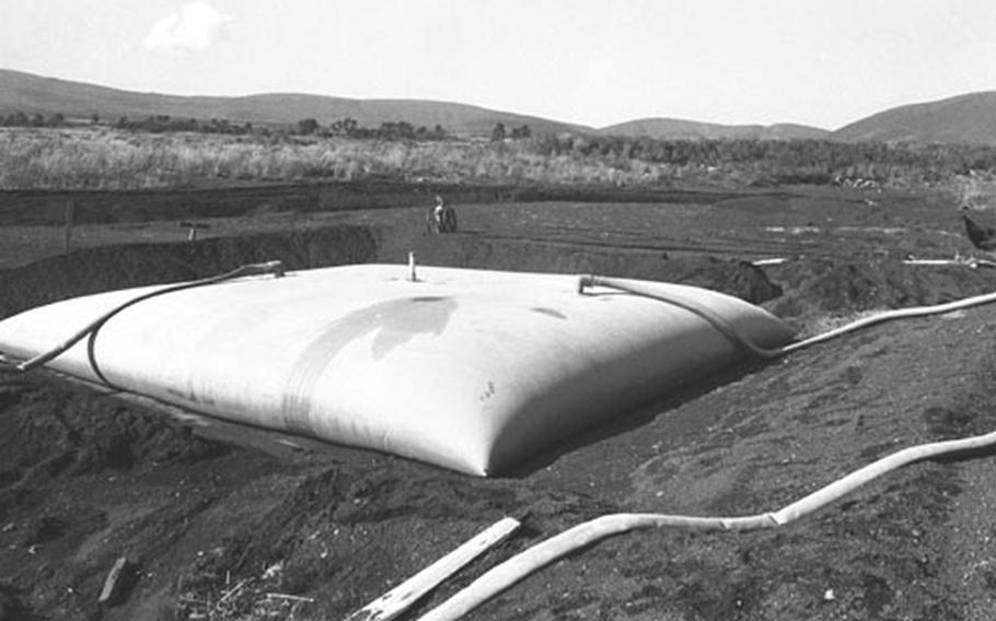 An undamaged fuel storage bladder at Camp Fuji after the fire. A similar one burst during a storm and sent 5,000 gallons of gasoline into the camp, where it ignited.