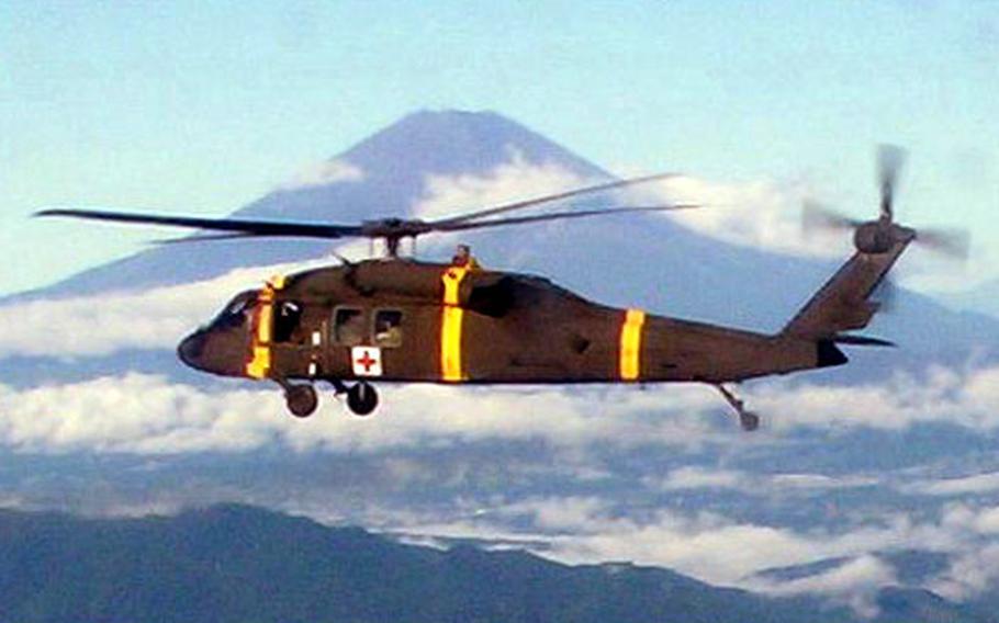 A South Korea-based U.S. Army dustoff helicopter passes Japan&#39;s Mount Fuji on Oct. 6 on its way back to Camp Humphreys in South Korea at the end of a training mission at Misawa Air Base, Japan.