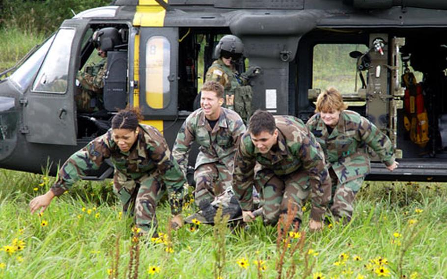 Airmen from the hospital at Misawa Air Base in Japan rush a mock litter case from a South Korea-based Army dustoff helicopter Sept. 22 during joint training at Misawa. Three Black Hawk medevac helos of the Army’s 377th Medical Company (Air Ambulance) flew by stages from their Camp Humphreys base in central South Korea to Misawa to give airmen insights into Army helicopter medevac methods.