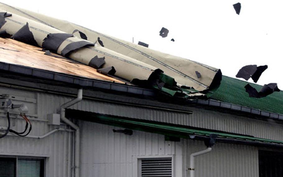 Powerful gusts of wind from Typhoon Tokage began rolling the roof off of Sasebo Naval Base’s Command U.S. Naval Forces Japan Regional Fire Department building on Wednesday. Tarpaper flew as the roof curled up a few yards at a time with each gust.