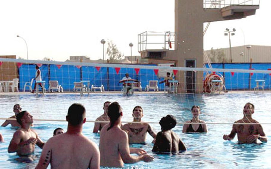 Soldiers enjoy the Olympic-size pool, complete with high dive, at LSA Anaconda, Iraq.