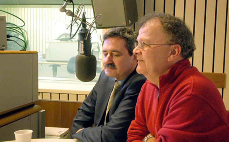 American Forces Network news director Gary Bautell, left, and former AFN director of broadcast services Herb Glover talk about the history of AFN in Frankfurt during the “AFN Morning Newswatch” show on the network’s last day of broadcast from the Frankfurt studios.