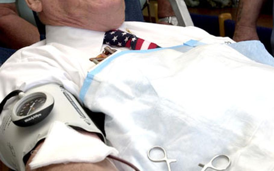 Dennis Provencher gives his 30th gallon of blood Thursday at 3rd Materiel Readiness Battalion&#39;s blood drive on Camp Kinser, Okinawa. Provencher, 71, said he has a certificate from the Guinness Book of World Records stating once held a world record for blood donation.